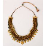 A 19TH / 20TH CENTURY INDIAN GOLD PERIDOT NECKLACE, 21 /24ct gold,
