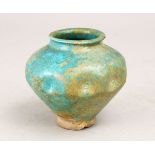 A GOOD 12TH CENTURY ILKHANID PERSIAN POTTERY MOULDED JAR, with a turquoise glaze , 9cm high,