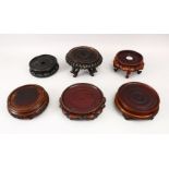 A MIXED LOT OF SIX 19TH / 20TH CENTURY CHINESE CARVED HARDWOOD STANDS, largest 23cm diameter,