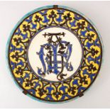 A SMALL ISLAMIC SPANISH BLUE AND YELLOW ENAMELLED POTTERY DISH, the centre with monogram, the border