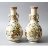 A GOOD PAIR OF JAPANESE MEIJI PERIOD SATSUMA TWIN HANDLE VASES, the body of the vases decorated with