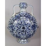 A CHINESE MING STYLE BLUE & WHITE PORCELAIN MOON FLASK, the domed sides decorated with a dense