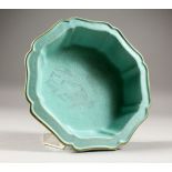 A GOOD CHINESE PALE BLUE / GREEN GROUND MOULDED PORCELAIN DISH, the dish with carved formal
