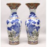 A LARGE PAIR OF JAPANESE MEIJI PERIOD BLUE AND WHITE PORCELAIN IMARI VASES, the bodyt of the vases