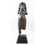 A LARGE INDIAN STONE STATUE OF A BULL HEADED GOD, POSSIBLY NANDI on a wooden stand, 73cm high on