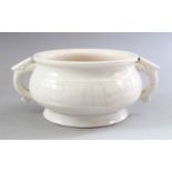 A GOOD CHINESE MOULDED BLANC DE CHINE CENSER, with twin moulded handles and archaic style decoration