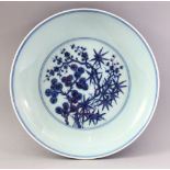 A GOOD CHINESE MING STYLE BLUE & WHITE PORCELAIN DISH, decorated depicting native flora and formal