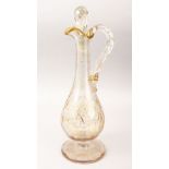 A GOOD 19TH CENTURY TURKISH GILDED GLASS EWER AND STOPPER, with gilded floral decoration, 41cm high,