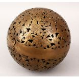 A LARGE 19TH CENTURY INDIAN OPENWORK BRASS HAND WARMER, with floral decor, 18cm high.