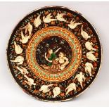 A GOOD 19TH/20TH CENTURY BOMBAY SCHOOL GLAZED POLYCHROME TERACOTTA CHARGER, depicting a four-armed