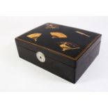 A GOOD JAPANESE MEIJI PERIOD LACQUER GAMES BOX, the hinged top decorated with five gilt fans, the