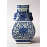 A GOOD CHINESE BLUE AND WHITE TWIN HANDLE PORCELAIN ZUN SHAPED VASE, the body with twin moulded