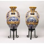 A LARGE PAIR OF 19TH CENTURY ISLAMIC POTTERY ALHAMBRA VASES AND STANDS, the vases with a central