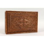 A LATE 19TH CENTURY INDIAN CARVED WOOD LIDDED BOX, the box carved with scenes of floral motifs,