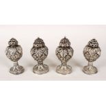 FOUR INDIAN SOLID SILVER SALT AND PEPPER SHAKERS, embossed with flowers and leaves, each approx.