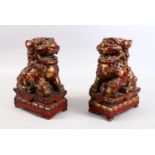 A PAIR OF 19TH CENTURY CHINESE CARVED WOOD & LACQUER FIGURES OF LION DOGS, each modelled upon a