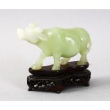 A GOOD CHINESE CARVED JADE / HARDSTONE FIGURE OF A COW, with a fitted hardwood stand, 8cm high x 9.