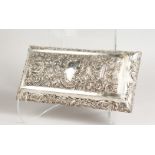A GOOD RECTANGULAR SILVER BOX, embossed with theatrical masks and flowers. London 1897. Maker: