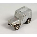 AN UNUSUAL ALUMINIUM TRENCH ART LIGHTER, modelled as a Land Rover. 3ins long.