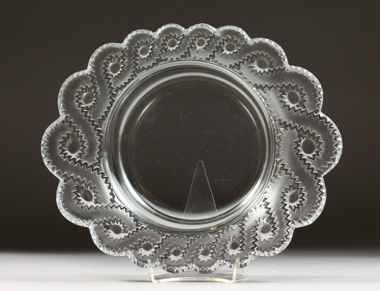 A HEAVY CIRCULAR LALIQUE DISH, with scalloped sides. Etched LALIQUE, FRANCE. 11ins diameter.