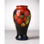 A MOORCROFT POTTERY VASE, blue ground, "Hibiscus". Impressed MOORCROFT, WM script. 7ins high.