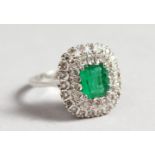 AN 18CT WHITE GOLD, DIAMOND AND EMERALD CLUSTER RING.