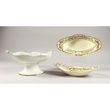 A PAIR OF CREAMWARE STRAWBERRY OVAL DISHES and A COMPORT, with fruiting vines.
