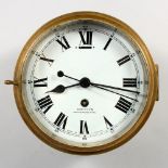 A SMITH BRASS CASED CIRCULAR "SHIPS" WALL CLOCK, with eight-day movement and enamel dial. Dial: 7ins