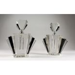 A PAIR OF ART DECO PLAIN AND BLACK SCENT BOTTLES AND STOPPERS.