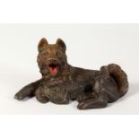 A HEAVY CAST BRONZE DOG. 6.5ins long.