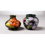 TWO SMALL MOORCROFT HIBISCUS BULBOUS VASES, one dated 2003. 3ins high (2).