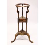 A GEORGE III STYLE MAHOGANY WASHSTAND, with a circular bowl aperture, two drawers, on three