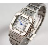 A CARTIER LADIES STAINLESS STEEL "SANTOS DE CARTIER" WRISTWATCH, with bracelet strap.