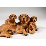 A SUPERB BLACK FOREST CARVED WOOD GROUP OF A DOG AND THREE PUPS. 10.5ins long. See Swiss Carvings,