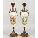 A PAIR OF FRENCH PORCELAIN AND CHAMPLEVE ENAMEL TWO-HANDLED VASES AND COVERS, with a large panel
