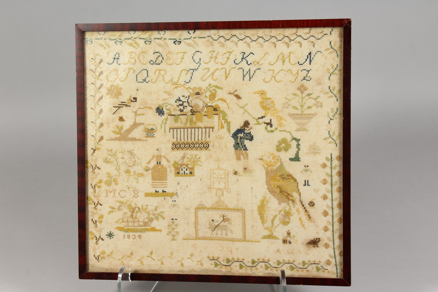 A 19TH CENTURY PICTORIAL ALPHABET SAMPLER, dated 1834, framed and glazed. 14.5ins x 13.5ins. - Image 2 of 8