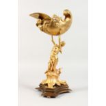 A GILT BRONZE FIGURE OF A MERMAID, holding aloft a shell, on a shaped base. 16ins high.