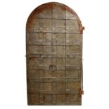 A VERY EARLY 14TH-15TH CENTURY CAST IRON DOOR, probably GERMAN, with a three action bolt lock. 6ft