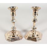 A PAIR OF 18TH CENTURY STYLE SILVER CANDLESTICKS, with knopped stems and octagonal bases.