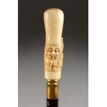 A VERY GOOD CHINESE CARVED BONE HANDLED WALKING CANE, head of a man with turtle. Handle: 5ins long.