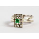 AN 18CT GOLD WHITE GOLD, EMERALD AND DIAMOND SET DESIGNER RING.