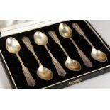 A SET OF SIX TEASPOONS, in a fitted case, stamped silver.