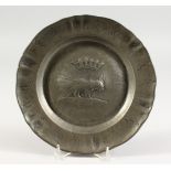 AN UNUSUAL PEWTER CIRCULAR DISH, the border with dolphins. 9.5ins diameter.