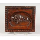 A RELIEF CARVED MAHOGANY PLAQUE OF A LION. 8.25ins wide.