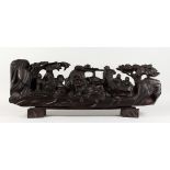 A LARGE CHINESE CARVED WOOD GROUP, many figures on a stand. 31ins long.