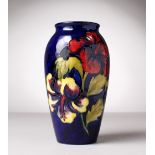 A MOORCROFT POTTERY VASE, blue ground, "Hibiscus". Impressed MOORCROFT with paper label. 7.5ins