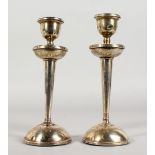 A PAIR OF CIRCULAR SILVER CANDLESTICKS, with loaded bases. Birmingham 1922. 8ins high.