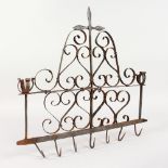 A WROUGHT IRON RACK, with candle holders and hooks. 16.5ins wide.