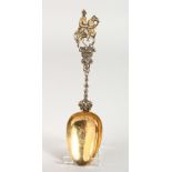 A CONTINENTAL SILVER GILT SPOON, with a cast handle depicting a horse and jockey. 8ins long.