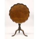 A GEORGE III MAHOGANY PIECRUST TILT TOP TRIPOD TABLE, the base with later carved decoration. 2ft